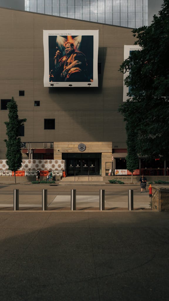 A cityscape featuring a large art display on a modern building facade.