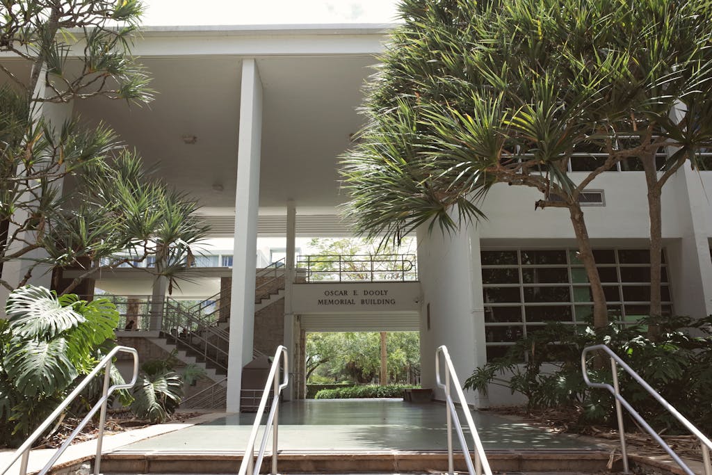 An outdoor view of the Oscar E. Dooly Memorial Building at a university campus with surrounding greenery.